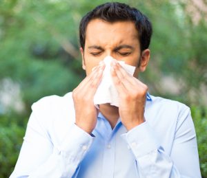 Man dealing with seasonal allergies