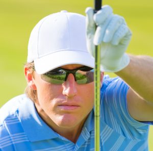 Man wearing specialty eyewear while golfing