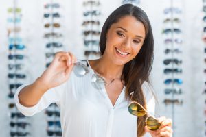 Woman looking at multiple pairs of eyewear
